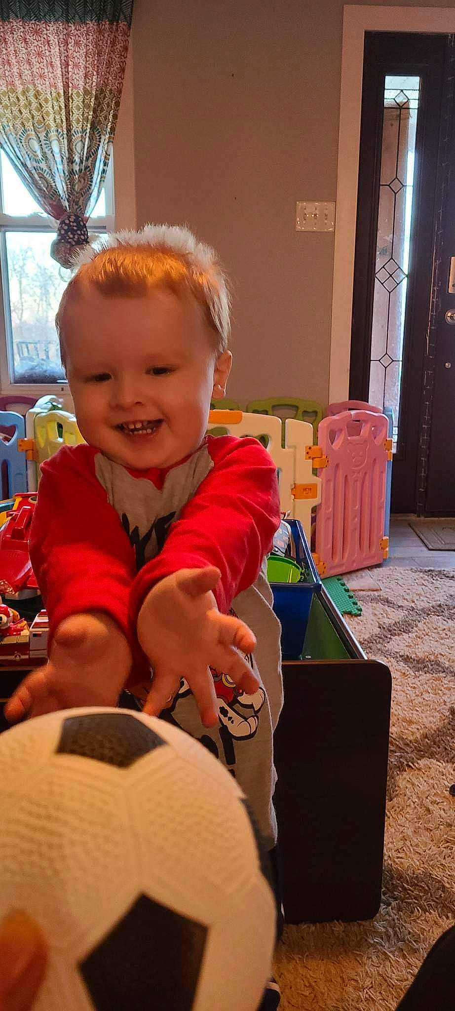 Charlie is registered to the contest to win money with this photo: baby, baby_playing_with_toys, baby_toddler_clothing, baby_toys, chair, child, door, flooring, fun, happy, joy, person, play, room, sitting, smile, standing, sun_hat, thumb, toddler