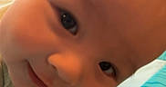 Kreminz joined the competition — help win amazing prizes! baby, child, close_up, colorful_mat, curious, cute, expression, eyes, fabric, face, head, human, indoors, infant, person, portrait, resting, skin, smiling, young