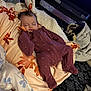 Poppy is registered to the contest to win money with this photo: baby, sleeping, blanket, onesie, purple_clothing, heart_pattern, indoor, soft_texture, floral_pattern, cozy, resting, child, infant, fabric, comfort, bed, pacifier, head, face, clothing