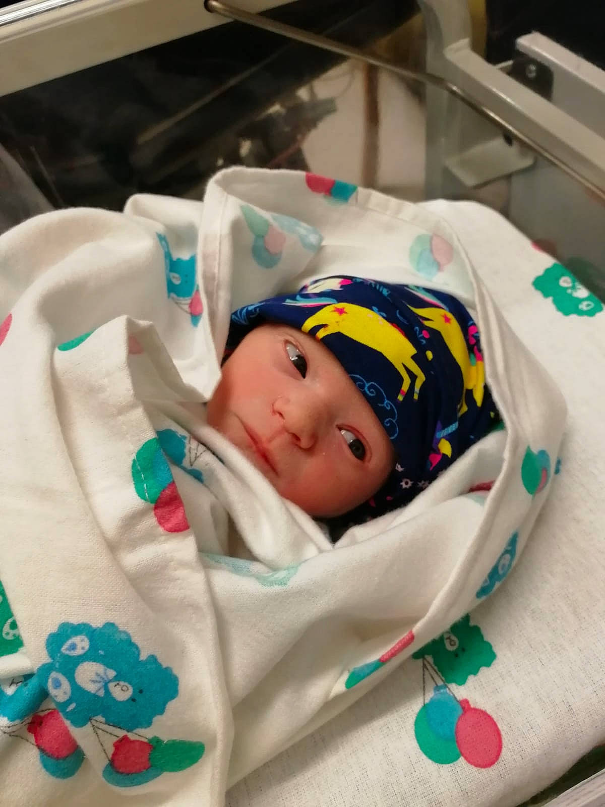 Nile is registered to the contest to win money with this photo: baby, baby_products, baby_safety, baby_sleeping, baby_toddler_clothing, child, comfort, hat, head, headwear, health_care, hospital, hospital_bed, linens, medical, medical_equipment, person, room, service, sleep