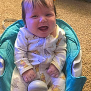 Calliope is registered to the contest to win money with this photo: baby, child, infant, smiling, happy, portrait, seated, high_chair, orange_bows, hair_bows, pajamas, onesie, carpet, indoor, home, turquoise_seat, face, hands, baby_furniture, photography