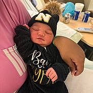 Nevaeh joined the competition — help win amazing prizes! baby, newborn, sleeping, hat, black_clothing, pom_pom, person, arm, hospital, bed, blanket, hand, face, indoor, relaxing, rest, cute, infant, cozy, portrait