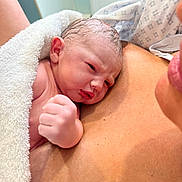Cruz is registered to the contest to win money with this photo: newborn, baby, infant, towel, skin, fist, resting, closeup, human, person, chest, love, care, family, fresh, soft, warmth, expression, newlife, bonding