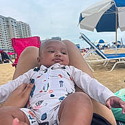 Cairo joined the competition — help win amazing prizes! baby, child, beach, swimsuit, umbrella, sand, relaxing, person, summer, vacation, outdoor, legs, hand, building, sky, chair, holiday, leisure, waterfront, comfort