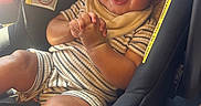 Cairo joined the competition — help win amazing prizes! baby, child, car_seat, smiling, sunglasses, striped_clothing, bib, hands, seatbelt, infant, cute, happy, portrait, indoor, person, seat, accessory, clothing, face, baby_toddler