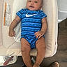 Cairo joined the competition — help win amazing prizes! baby, child, infant, blue_onesie, nike_logo, baby_seat, beige, wooden_floor, footwear, slipper, relaxed, curious, indoor, flooring, person, legs, feet, casual, comfort, home