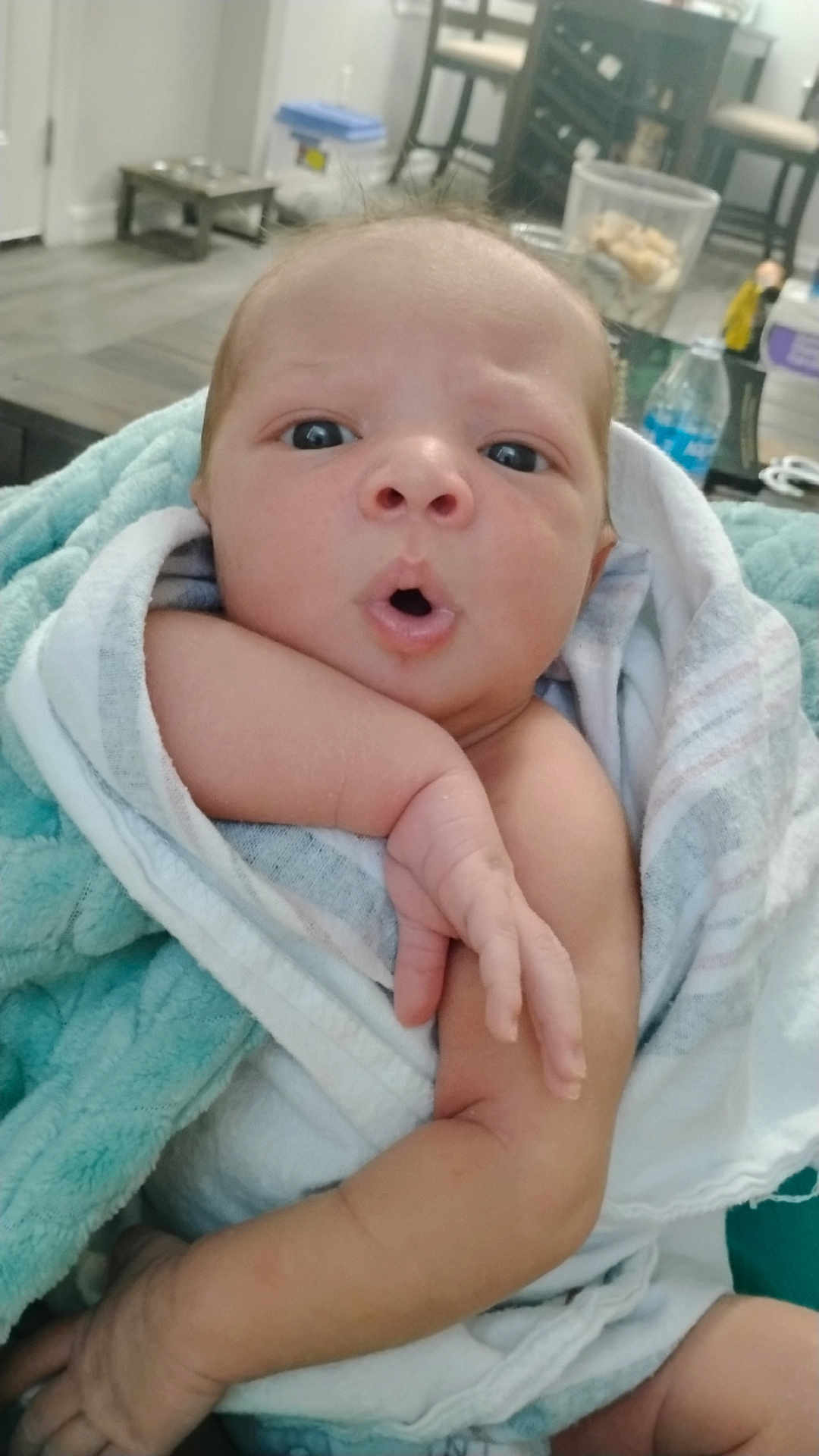Kylon joined the competition — help win amazing prizes! baby, infant, towel, wrapped, face, expression, hand, skin, indoors, home, furniture, blurred_background, newborn, person, cute, child, soft_texture, blanket, curious, portrait