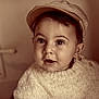 baby, child, face, hat, knitted_sweater, portrait, curious, wide_eyes, sepia, vintage, cozy, cute, indoor, infant, person, headwear, young_child, warm_tones, expression, closeup
