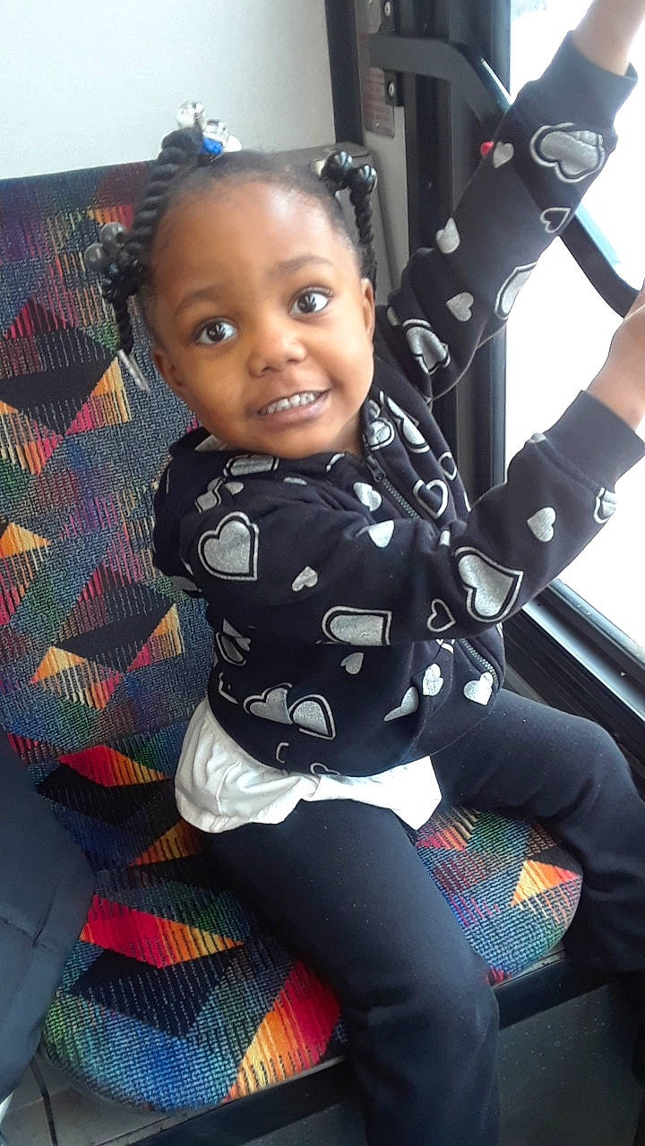 Nia joined the competition — help win amazing prizes! baby, black_hair, car_seat, child, design, joy, pattern, person, sitting, smile, toddler