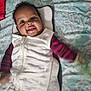 baby, babylaughing, bed, blanket, clothing, coat, cushion, face, furniture, happy, head, homedecor, jacket, laughing, pants, person, photography, portrait, quilt, smile