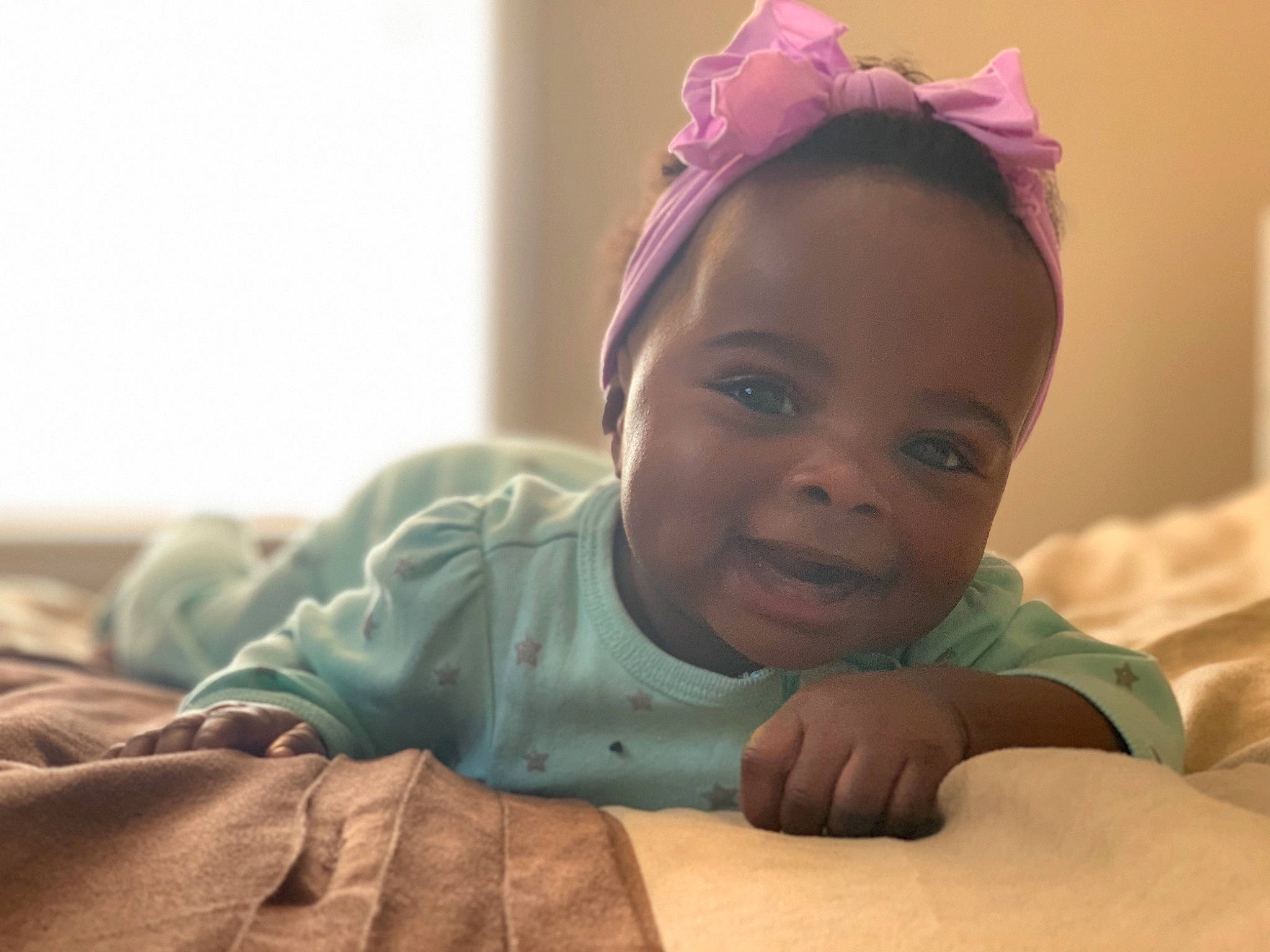 Charisma is registered to the contest to win money with this photo: baby, cheek, child, ear, eye, face, forehead, hair, hair_accessory, hand, happy, head, human, nose, person, photography, sitting, skin, smile, toddler