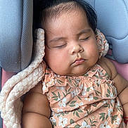Evangeline joined the competition — help win amazing prizes! adorable, baby, blanket, car_seat, child, chubby_arms, close_up, comfort, cute, floral_dress, hair_clip, indoors, infant, peace, peaceful, portrait, relaxation, resting, sleeping, soft_lighting