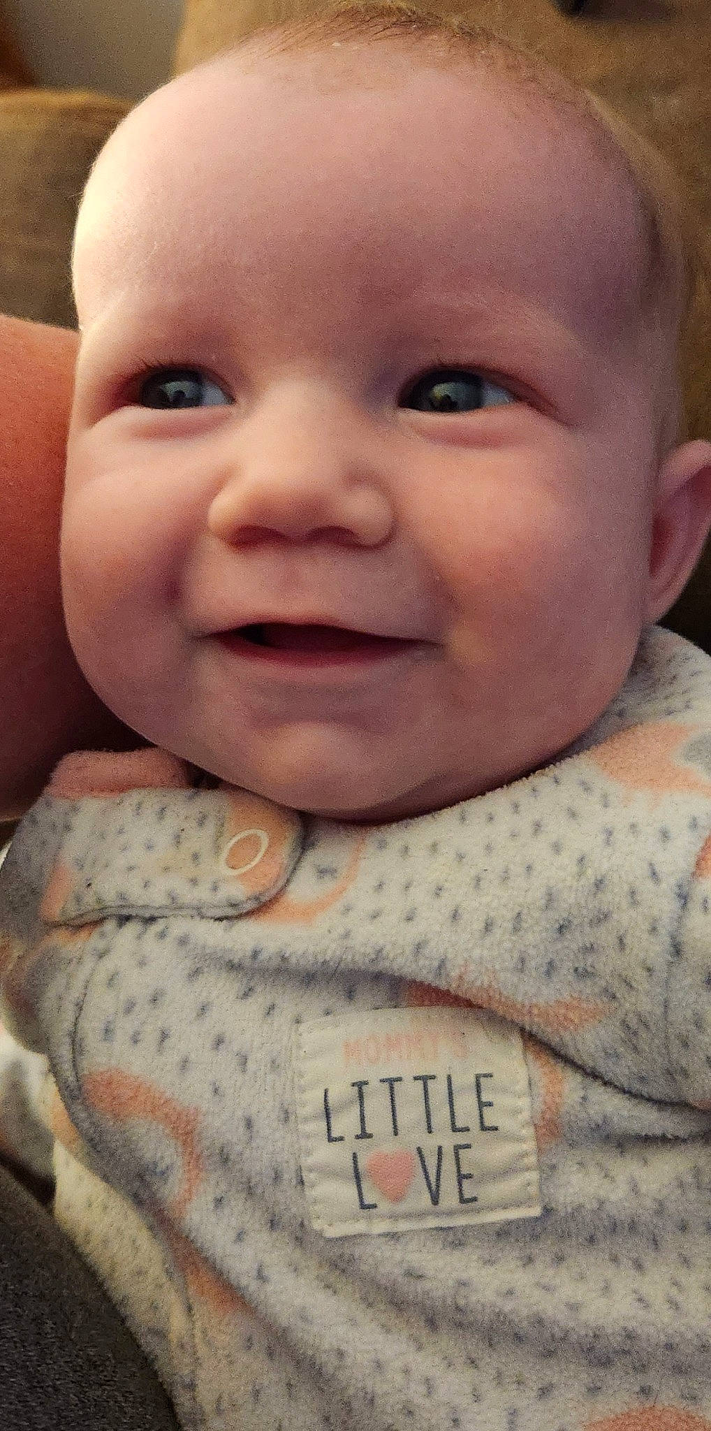 Marley is registered to the contest to win money with this photo: arm, baby, cheek, chin, eye, eyebrow, eyelash, forehead, gesture, hand, happy, human_body, iris, joy, lip, mouth, muscle, neck, nose, person