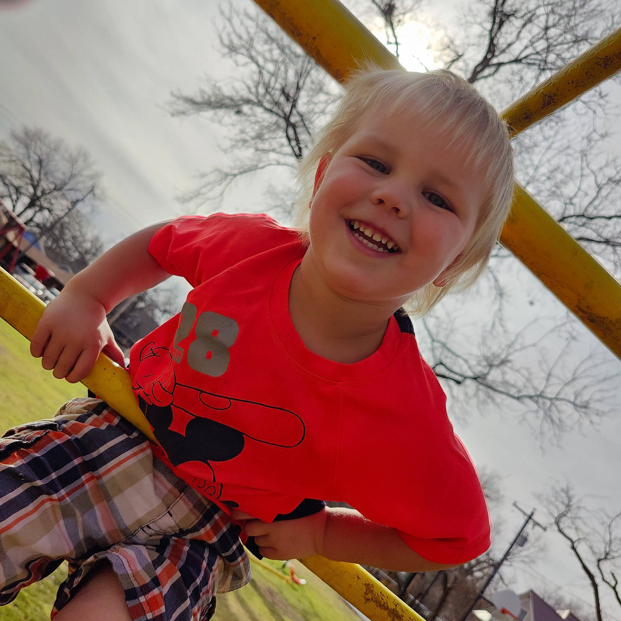 Jrue is registered to the contest to win money with this photo: child, fun, grass, happy, joy, leisure, musical_instrument, outdoor_play_equipment, pattern, person, plaid, play, product, public_space, recreation, sky, smile, t_shirt, tartan, toddler