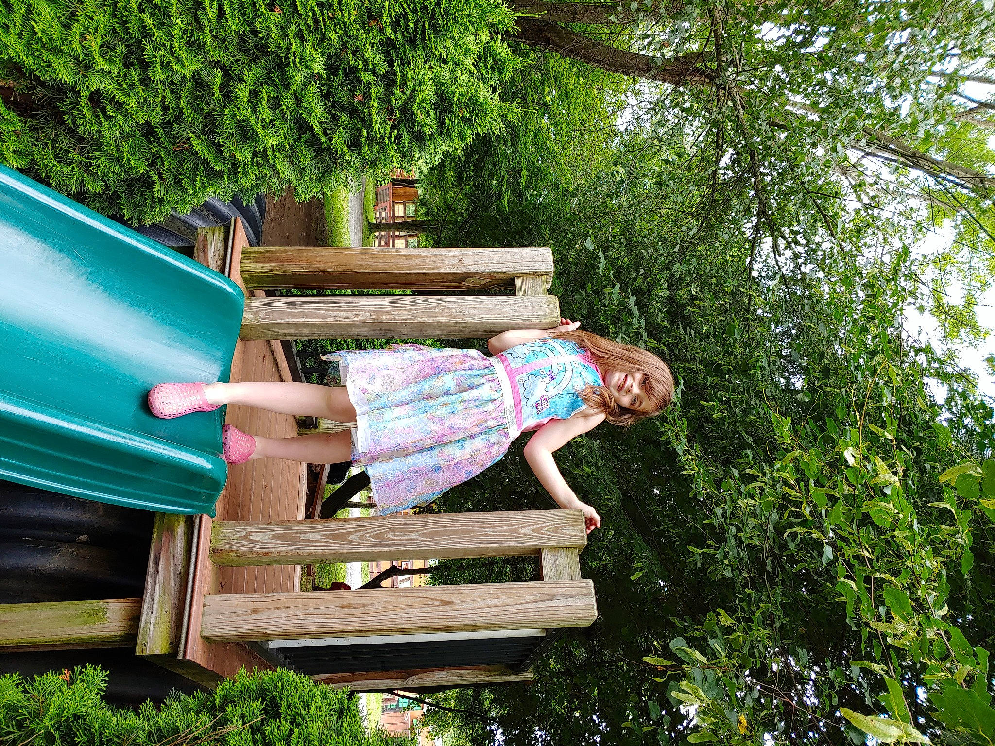 Riley Lynn is registered to the contest to win money with this photo: backyard, child, chute, fun, garden, grass, happy, joy, leisure, outdoor_bench, outdoor_furniture, people_in_nature, person, plant, recreation, shrub, sitting, spring, toddler, tree