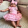 Everlee joined the competition — help win amazing prizes! baby, blanket, child, closeup, couch, dress, family, fashion, frilly_dress, happy, home, indoor, infant, lying_down, pillow, pink_bow, pink_outfit, portrait, sitting, smiling
