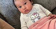Everlee is registered to the contest to win money with this photo: baby, blanket, cartoon, child, couch, cozy, face, furniture, hair_bows, hello_kitty, indoors, infant, photography, pigtails, pink_clothing, portrait, sitting, smiling, sofa, white_shirt