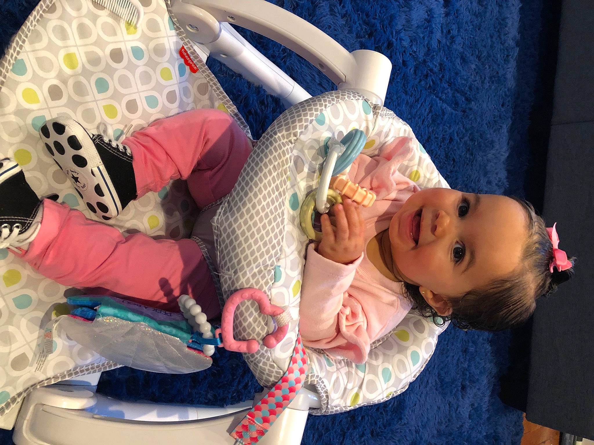 Arielle is registered to the contest to win money with this photo: arm, baby, baby_carriage, baby_products, bag, child, fashion_accessory, fun, hairstyle, happy, joy, leisure, linens, luggage_and_bags, pattern, person, pink, product, sitting, smile