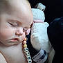 baby, sleeping, pacifier_clip, beads, stuffed_animal, soft_toy, child, face, peaceful, infant, cute, resting, closeup, skin, head, nap, indoors, comfort, adorable, childhood