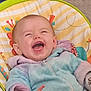 baby, laughing, child, infant, jacket, pastel_colors, baby_seat, colorful, happy, smiling, cozy, indoor, cute, young_child, face, hand, clothing, seatbelt, playful, portrait