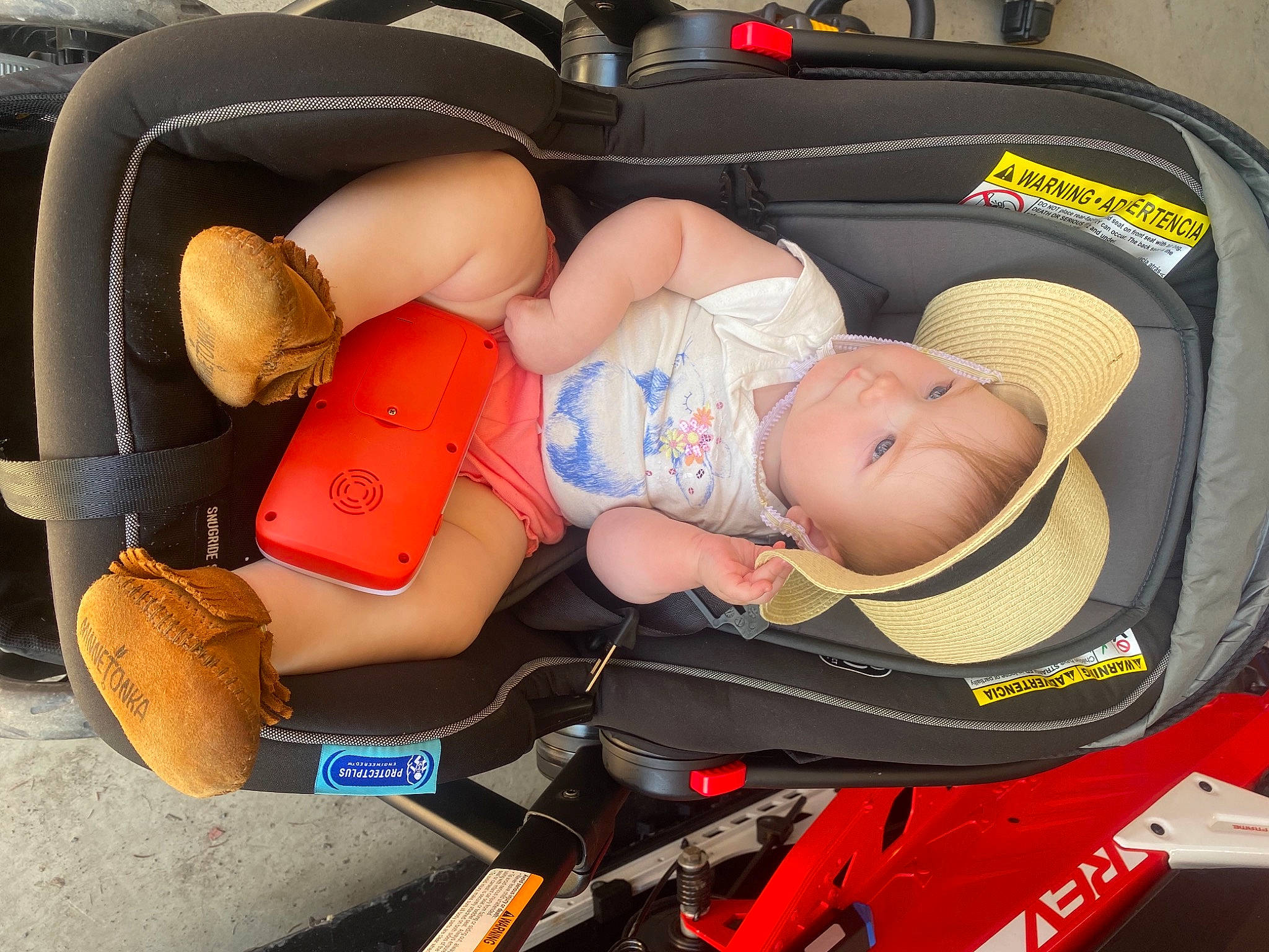 Giavanna is registered to the contest to win money with this photo: auto_part, automotive_design, baby, baby_carriage, baby_products, bag, car_seat, child, comfort, fun, hat, human_body, lap, leg, motor_vehicle, orange, person, thigh, tire, toddler