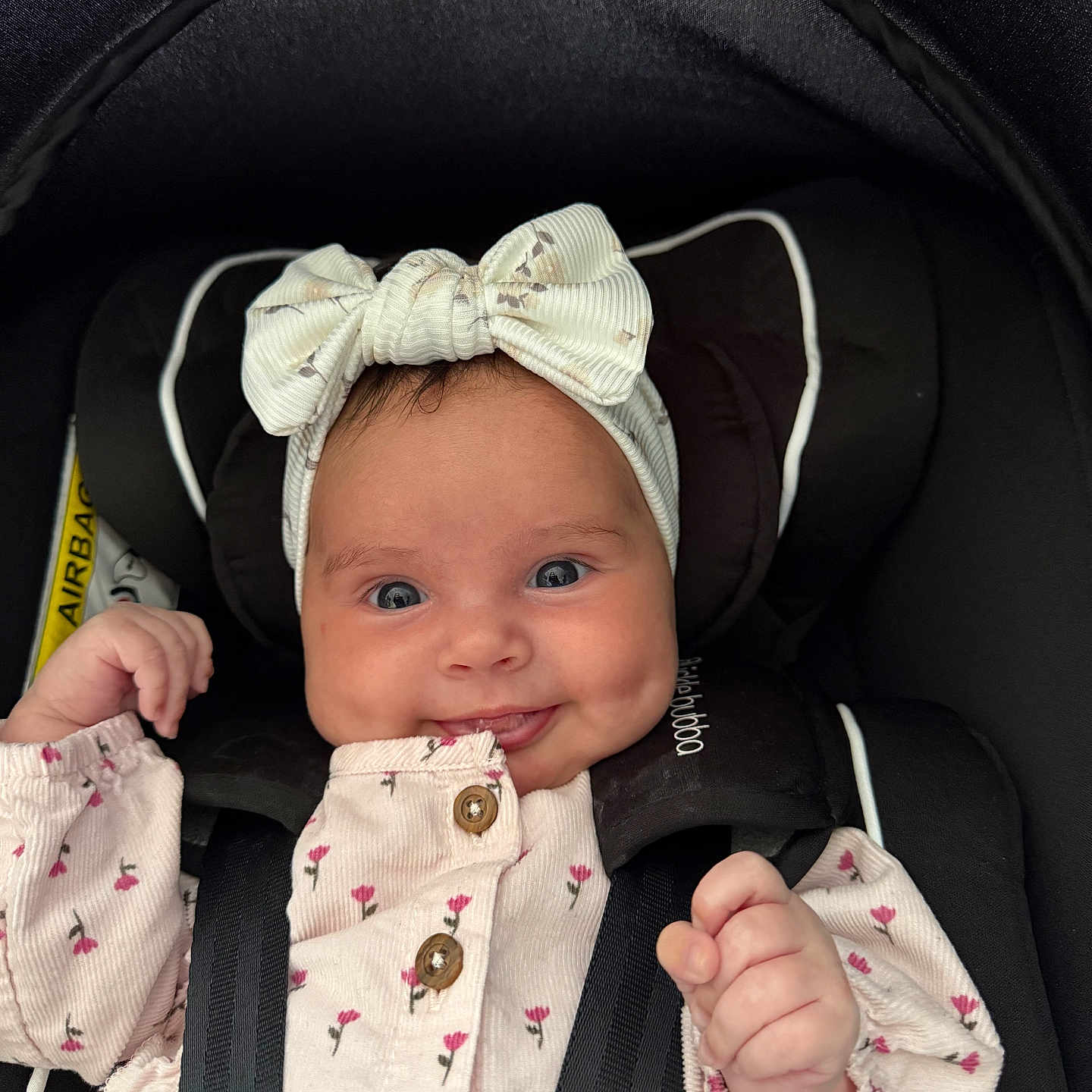 Connie joined the competition — help win amazing prizes! baby, bow, car_seat, child, closeup, clothing, cute, dimples, face, floral, happy, headband, indoor, infant, person, pink, portrait, safety, smiling, straps