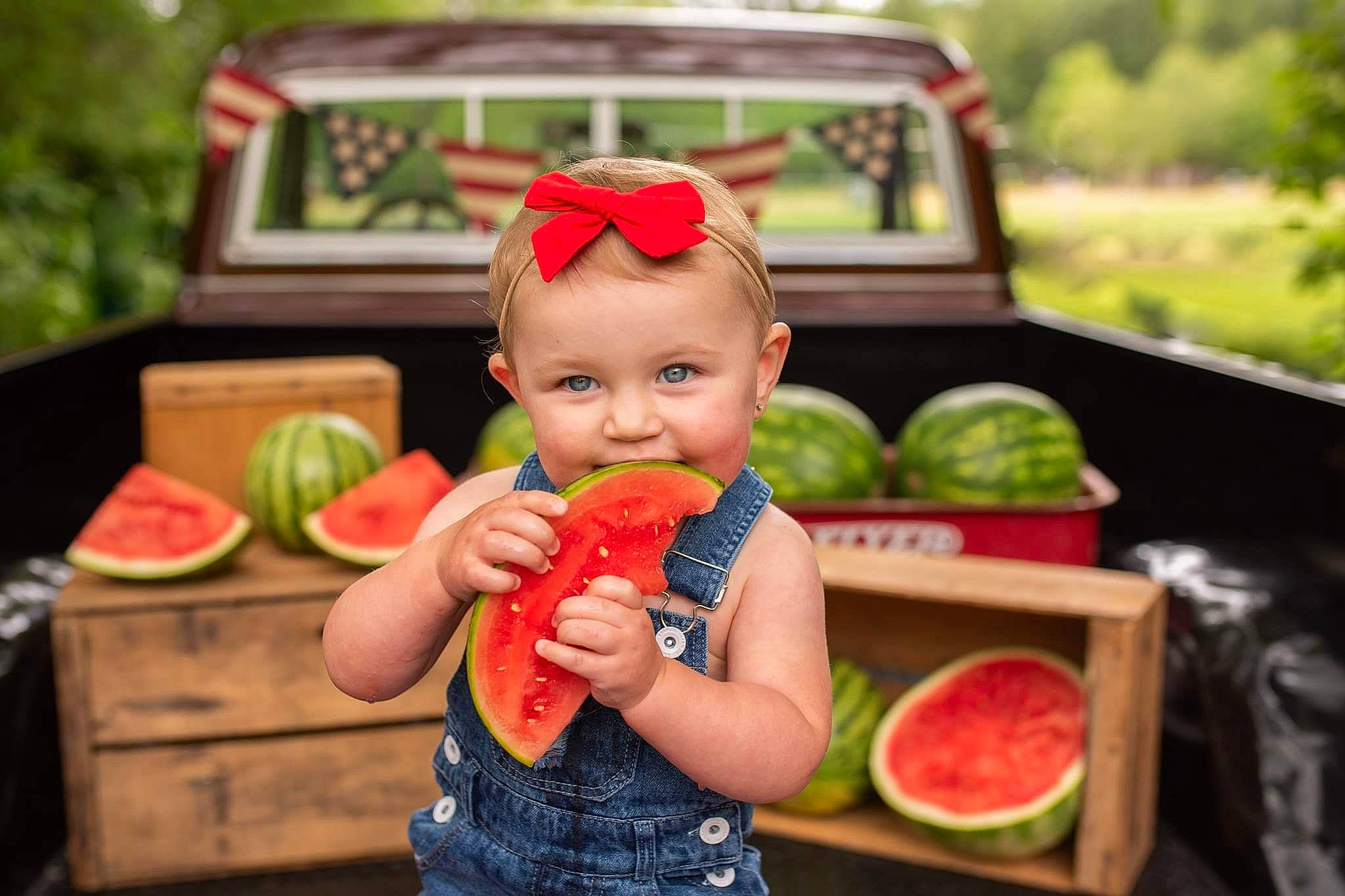 Adelyn is registered to the contest to win money with this photo: arm, citrullus, citrus, dress, food, fruit, grass, green, hand, happy, natural_foods, orange, person, plant, product, seedless_fruit, skin, sunglasses, toddler, tree