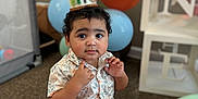 Kash is registered to the contest to win money with this photo: baby, balloons, birthday, carpet, celebration, child, clothing, crown, cute, decorations, festive, floor, home, indoor, one_year_old, party, person, portrait, smiling, toddler