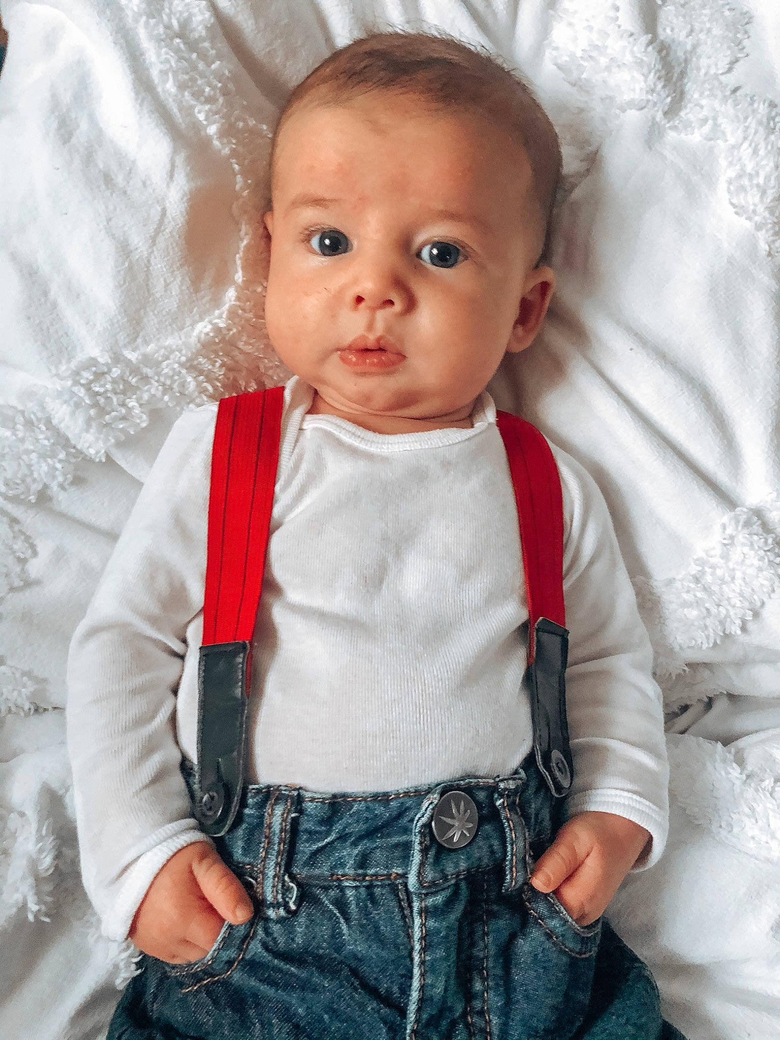 Boone is registered to the contest to win money with this photo: abdomen, baby, baby_products, baby_toddler_clothing, cheek, child, child_model, eye, face, head, jeans, nose, person, product, sitting, toddler, trunk, white