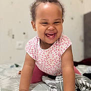 Houraye a rejoint le concours — aidez-le/la à gagner de superbes lots ! baby, toddler, child, smile, laughing, crawling, pink_clothing, curly_hair, earrings, bed, blanket, indoor, happy, cute, person, portrait, infant, young_child, home, playful