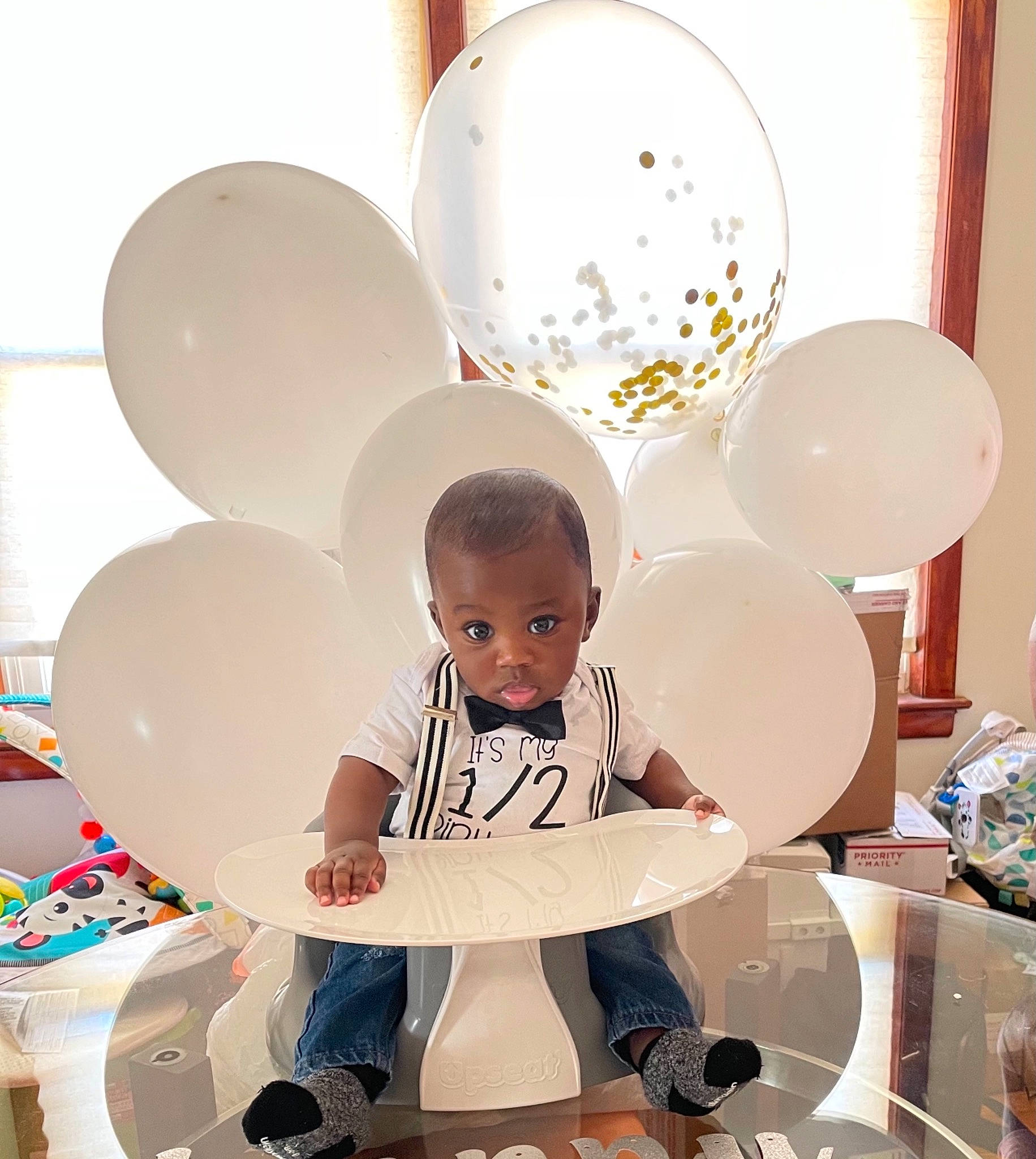 Dillon is registered to the contest to win money with this photo: art, baby, baby_toddler_clothing, ceiling, chair, child, circle, comfort, dishware, happy, interior_design, lighting_accessory, material_property, metal, person, photograph, product, room, sitting, space