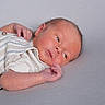 Carter is registered to the contest to win money with this photo: baby, clothing, cute, expression, eyes, face, hand, head, human, infant, lying_down, newborn, peaceful, portrait, resting, skin, small, soft_surface, striped_outfit, young