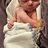Carter is registered to the contest to win money with this photo: newborn, baby, sleeping, infant, portrait, blanket, swaddled, pacifier, indoors, cozy, peaceful, face, closed_eyes, skin, textile, soft, cuddled, nursery, resting, photography