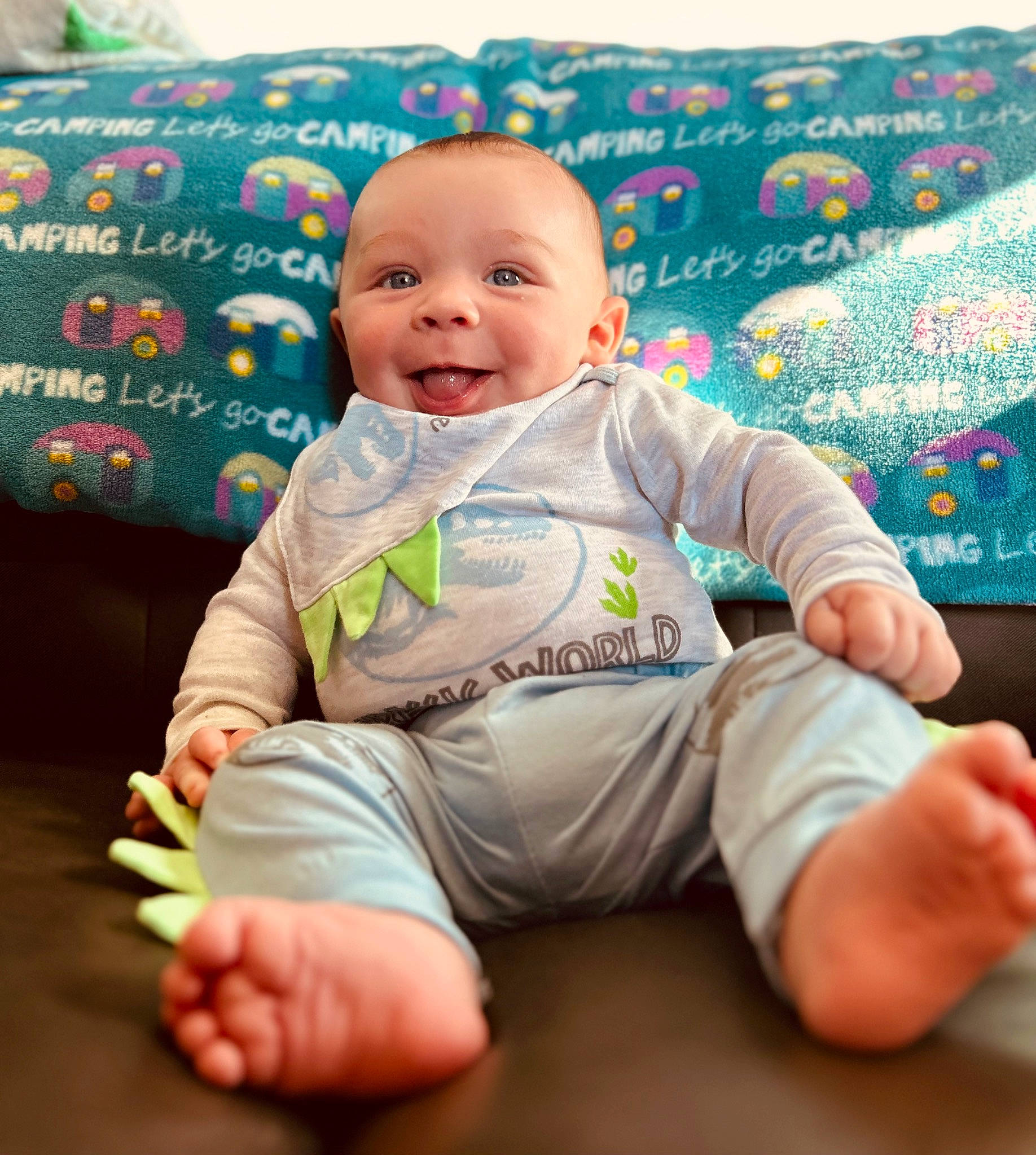 Boone is registered to the contest to win money with this photo: baby, baby_toddler_clothing, barefoot, cheek, child, comfort, couch, finger, foot, fun, happy, linens, person, product, sitting, skin, sleeve, smile, t_shirt, thumb