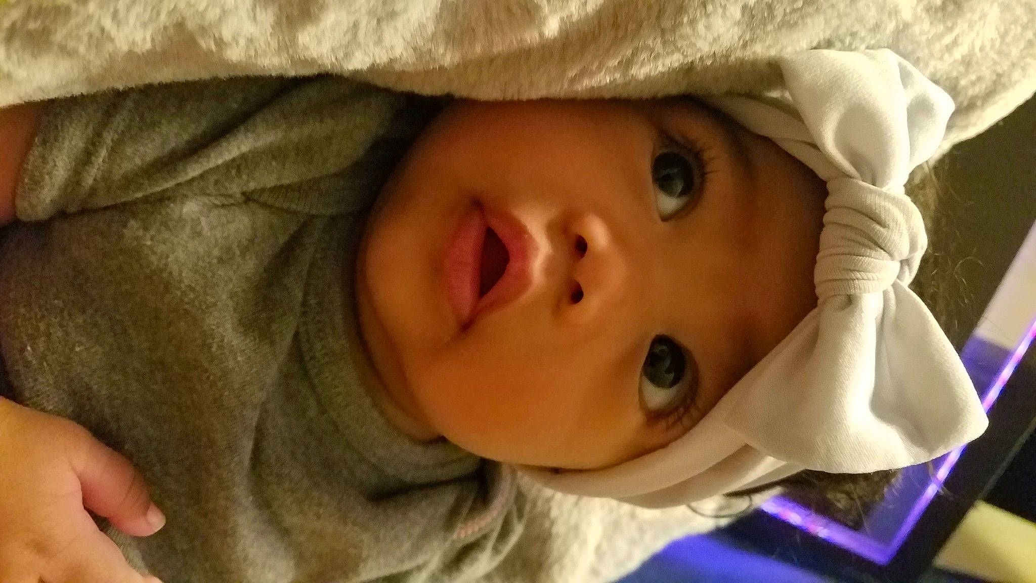 Lyra is registered to the contest to win money with this photo: baby, cheek, child, chin, comfort, eye, eyebrow, eyelash, face, facial_expression, finger, forehead, happy, headwear, iris, lip, mouth, nose, person, skin