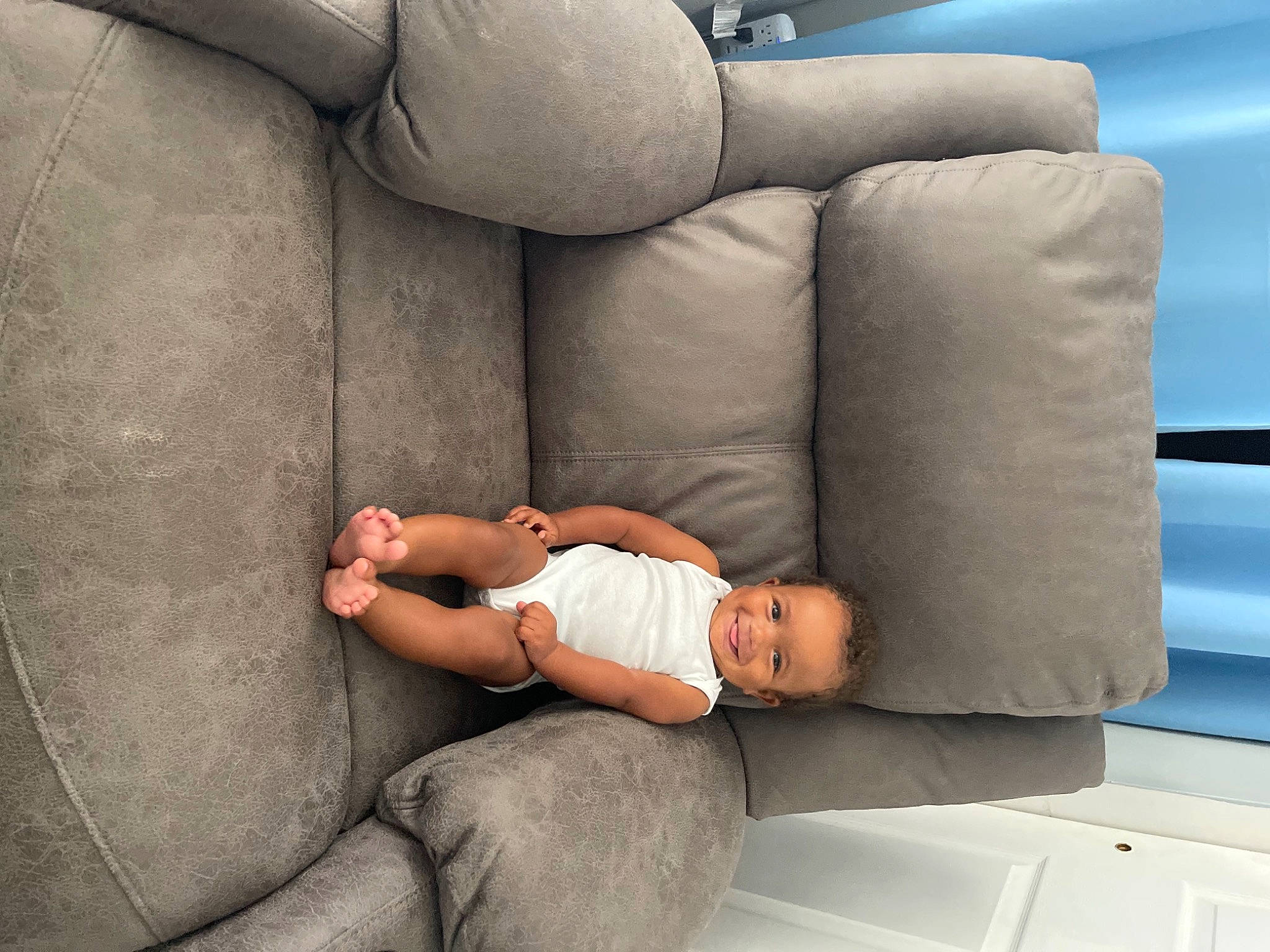 Neo is registered to the contest to win money with this photo: automotive_design, car_seat, child, comfort, couch, elbow, foot, human_leg, joy, knee, lap, leg, leisure, linens, luxury_vehicle, nap, person, sitting, sofa_bed, thigh