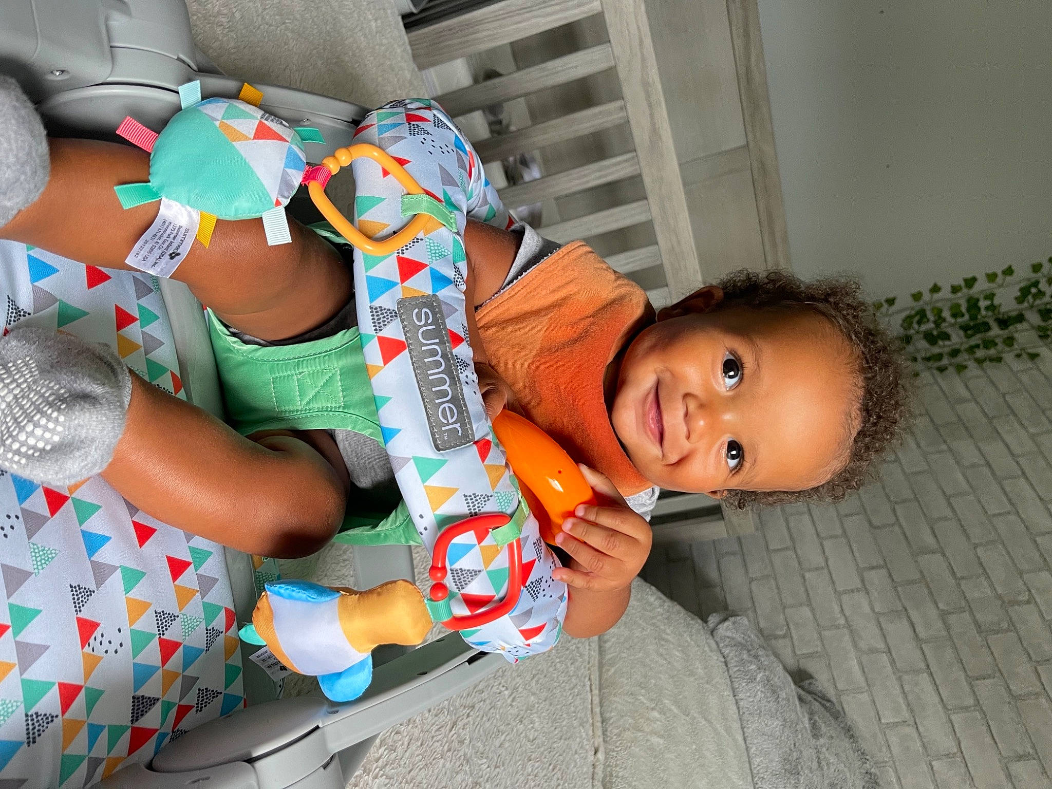 Neo joined the competition — help win amazing prizes! baby, baby_products, baby_toddler_clothing, child, comfort, fun, happy, human_leg, joint, joy, lap, nail, pattern, person, plastic, play, room, sandal, sitting, smile