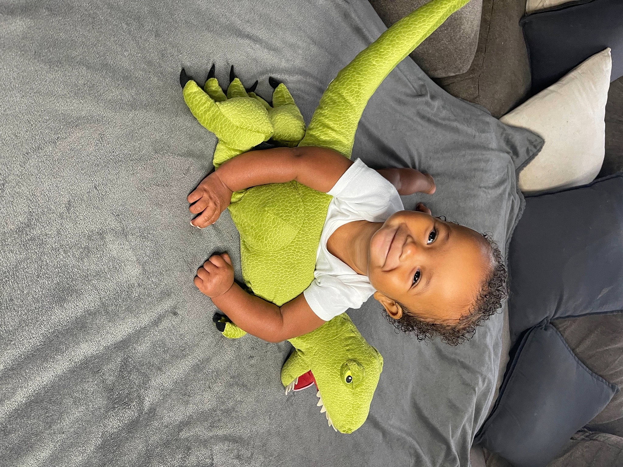 Neo is registered to the contest to win money with this photo: arm, baby_products, baby_toddler_clothing, child, comfort, couch, finger, flooring, fun, gesture, happy, joint, joy, leisure, linens, person, play, room, stuffed_toy, t_shirt