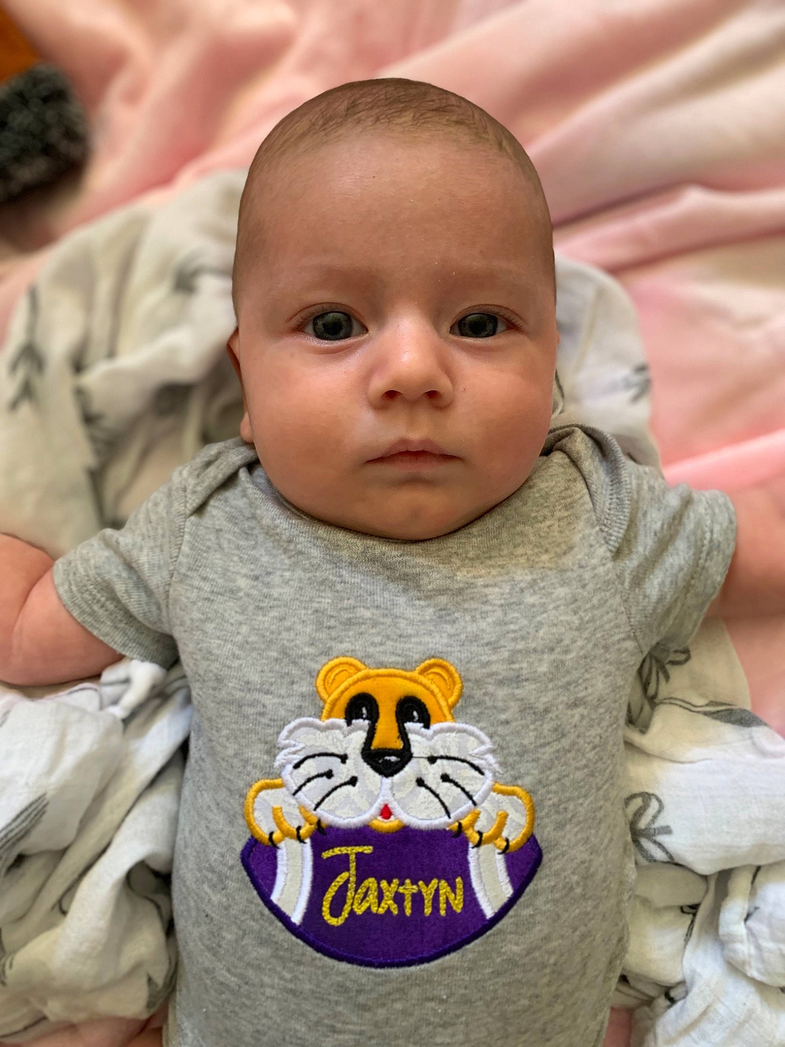 Jaxtyn is registered to the contest to win money with this photo: baby, baby_toddler_clothing, bib, cheek, eye, facial_expression, forehead, happy, head, lip, mammal, mouth, nose, organ, people, person, product, skin, sleeve, toddler