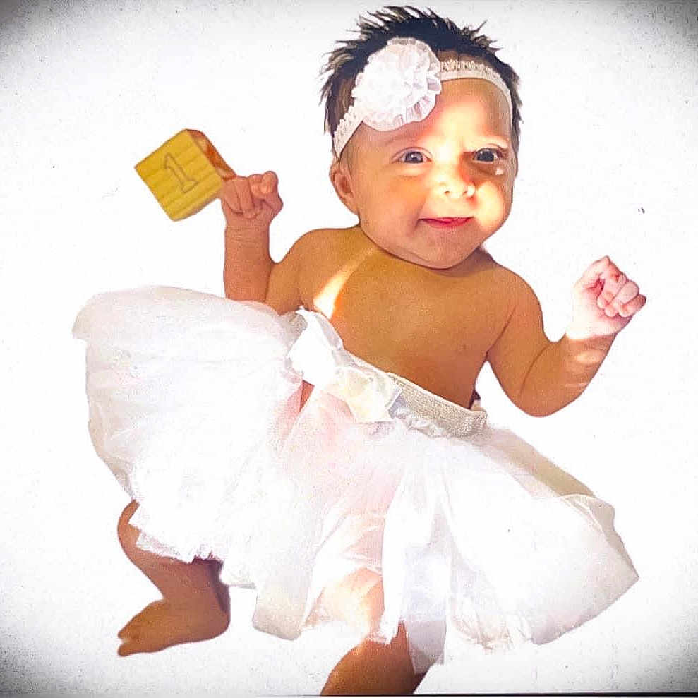 Amariah joined the competition — help win amazing prizes! accessories, baby, bodypart, clothing, costume, creditcard, diaper, dress, face, finger, flower, food, formalwear, hand, head, person, photography, plant, portrait, text