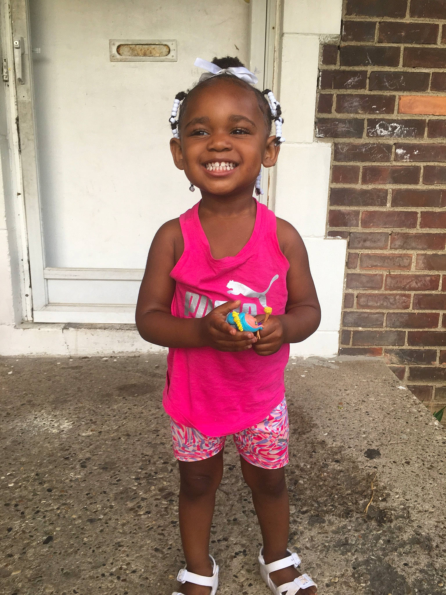 Aiyanna is registered to the contest to win money with this photo: adaptation, child, face, fun, happy, head, joy, magenta, people, person, pink, skin, smile, summer, t_shirt, toddler, vacation