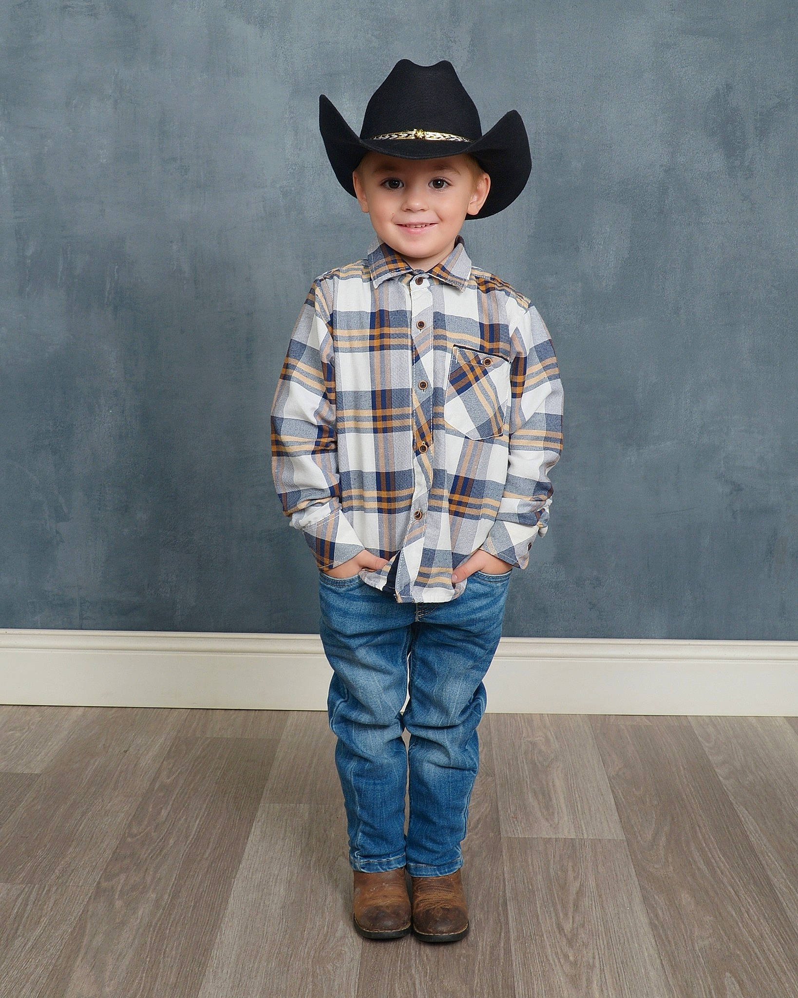 Jaxton is registered to the contest to win money with this photo: clothing, collar, denim, dress_shirt, face, flash_photography, flooring, happy, hat, headwear, jeans, joy, neck, person, plaid, sleeve, smile, standing, sun_hat, t_shirt