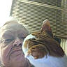 Moe joined the competition — help win amazing prizes! person, cat, indoor, selfie, window_blinds, orange_cat, white_cat, close_up, face, pet, animal, curious, smile, human, companion, domestic, feline, casual, portrait, window