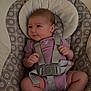 baby, infant, onesie, baby_seat, straps, patterned_cushion, soft_toy, cute, child, indoors, human, legs, feet, hands, head, face, comfort, resting, looking, seat
