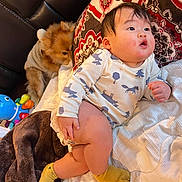 Kingston is registered to the contest to win money with this photo: baby, child, dog, pillow, blanket, bed, socks, clothing, animal_print, fur, pet, cute, infant, furniture, indoor, resting, toy, pattern, soft, cozy