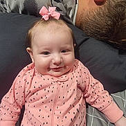 Kinsler joined the competition — help win amazing prizes! baby, infant, pink_bow, pink_onesie, polka_dots, smiling, face, person, adult, man, hair, pillow, bed, blanket, sleeping, resting, indoor, cozy, family, cute