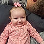 baby, infant, pink_bow, pink_onesie, polka_dots, smiling, face, person, adult, man, hair, pillow, bed, blanket, sleeping, resting, indoor, cozy, family, cute