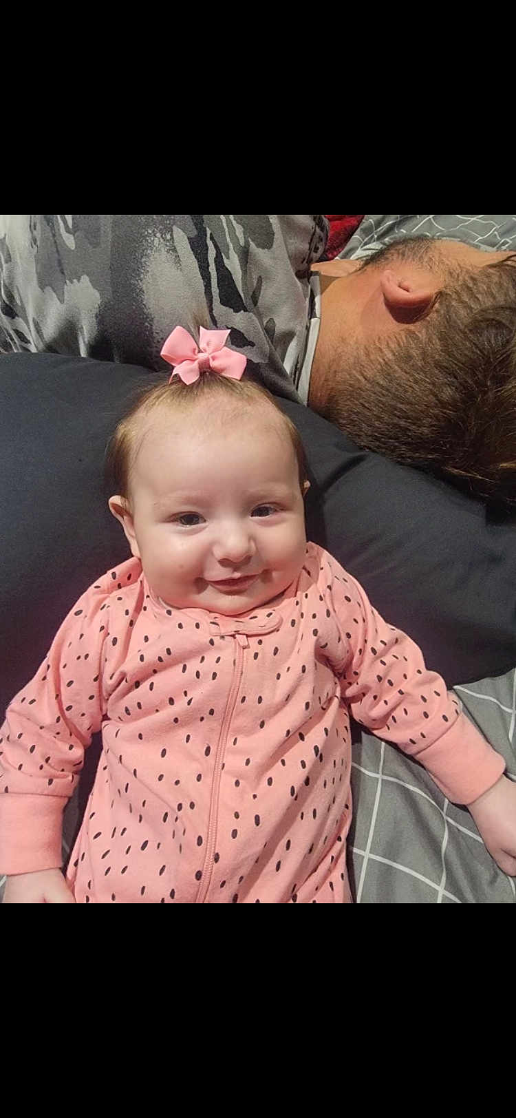 Kinsler joined the competition — help win amazing prizes! baby, infant, pink_bow, pink_onesie, polka_dots, smiling, face, person, adult, man, hair, pillow, bed, blanket, sleeping, resting, indoor, cozy, family, cute
