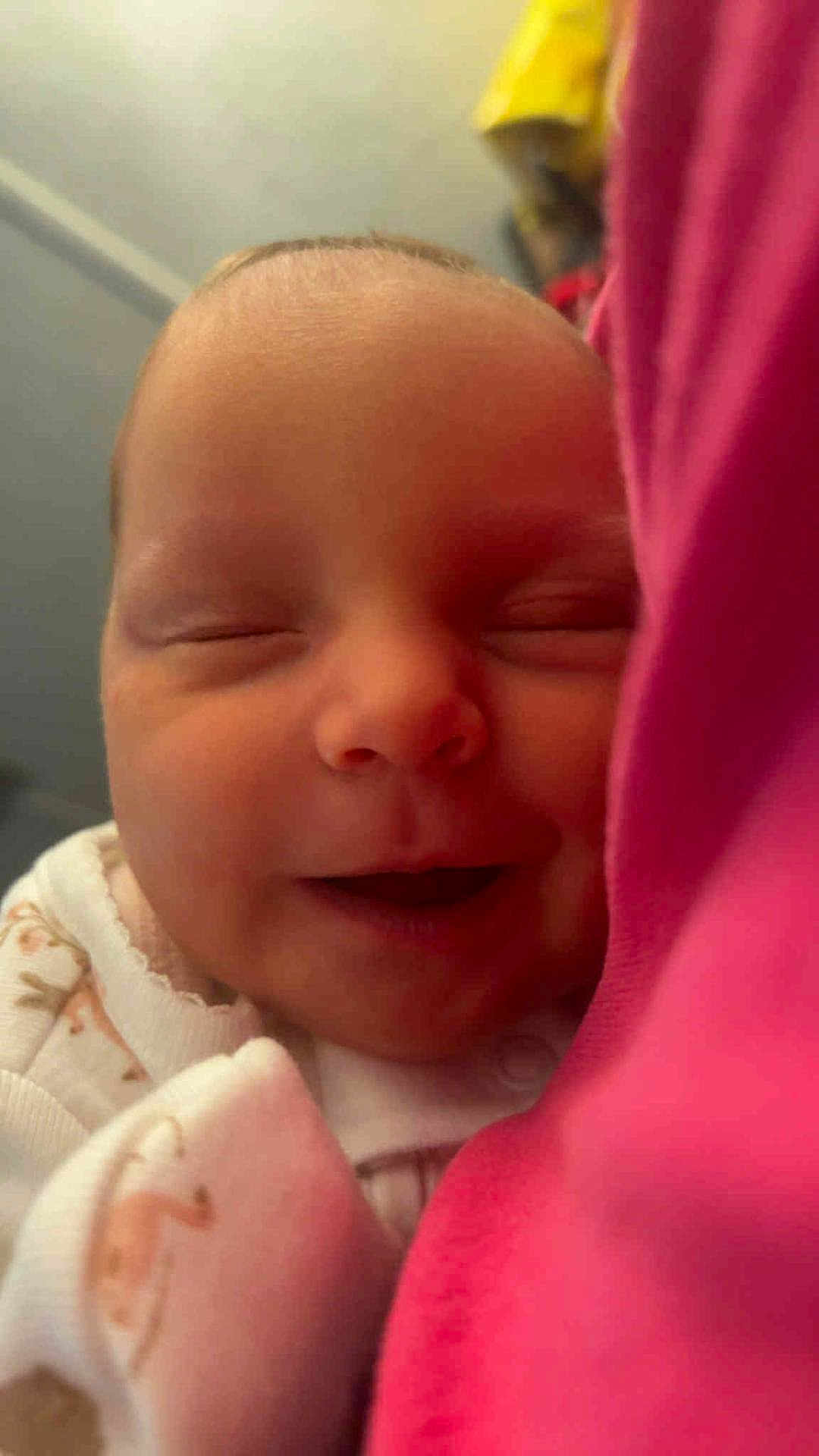 Brielle is registered to the contest to win money with this photo: baby, infant, face, smiling, closed_eyes, pajamas, blanket, pink, skin, newborn, sleeping, cute, child, portrait, cozy, soft, peaceful, closeup, indoors, comfort