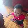 toddler, child, indoor, wooden_floor, red_couch, clothing, sneakers, chain, pose, curly_hair, person, footwear, fashion, home, casual, young_child, expression, standing, floor, living_room
